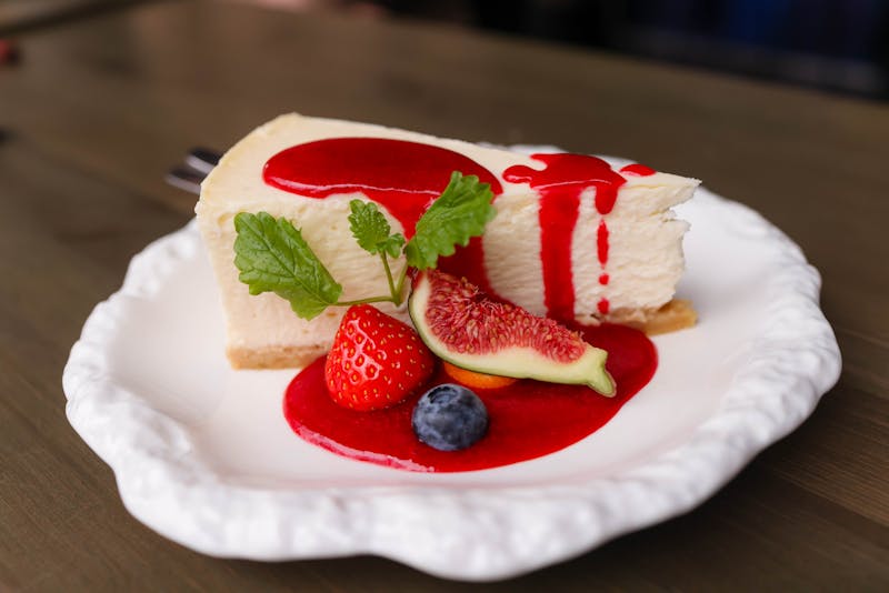 Cheesecake dessert slice with berry compote