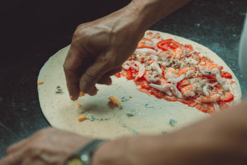 Apache Pizza kitchen with fresh ingredients being prepared